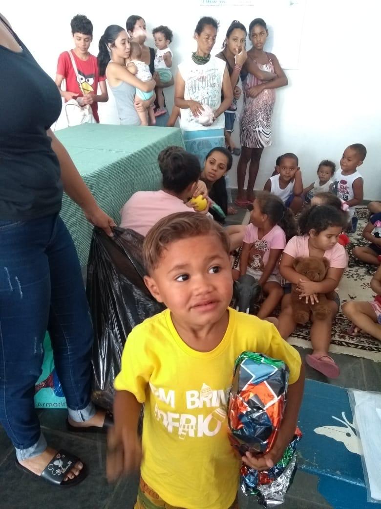 Criança com presente em encontro comunitário